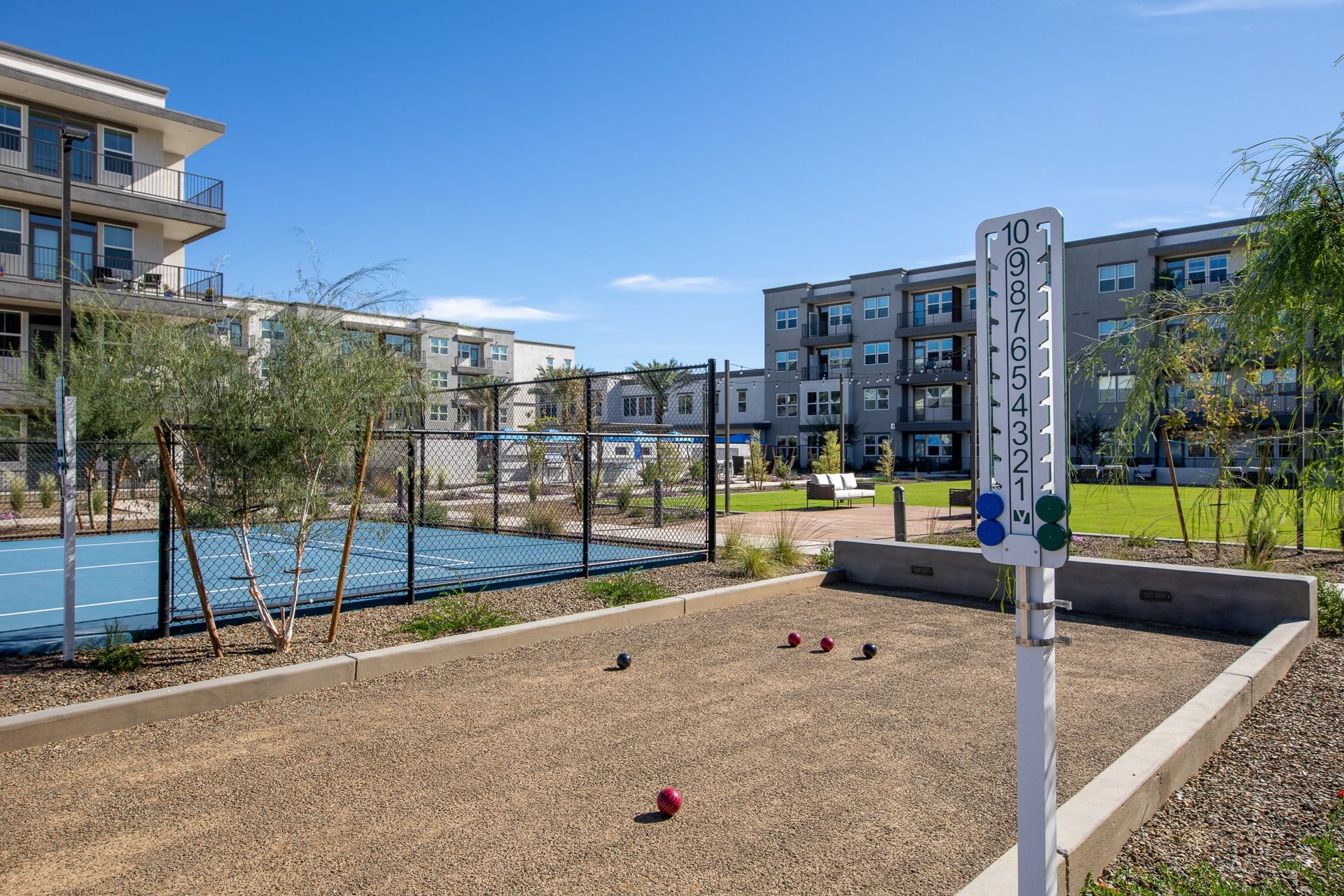 a bocce court, pickleball court, and lawn at a senior apartment community